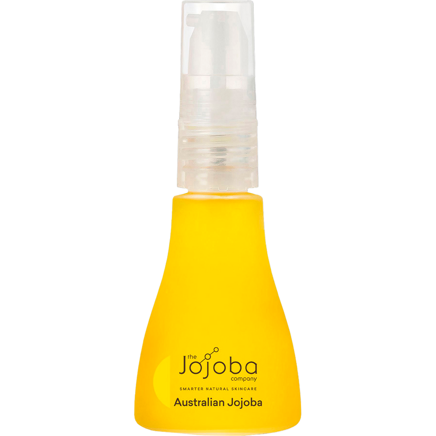 Woman applying Australian jojoba oil on face for natural moisturising and glow