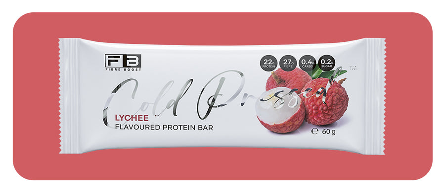 Lychee-flavored protein bar packaging on a red background
