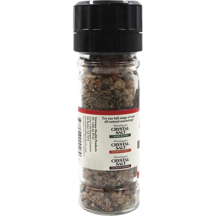 Himalayan salt and pepper glass grinder by Nirvana Organics on kitchen counter