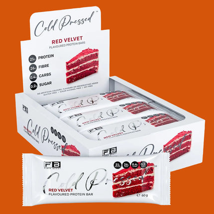 Red Velvet flavored protein bars in a display box with packaging showing nutritional information.