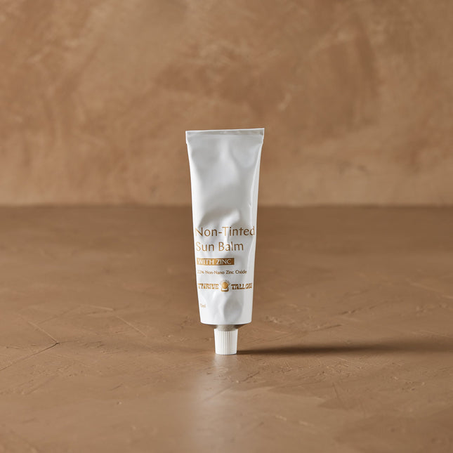Thrive Tallow Tube of Sun Balm on a brown background
