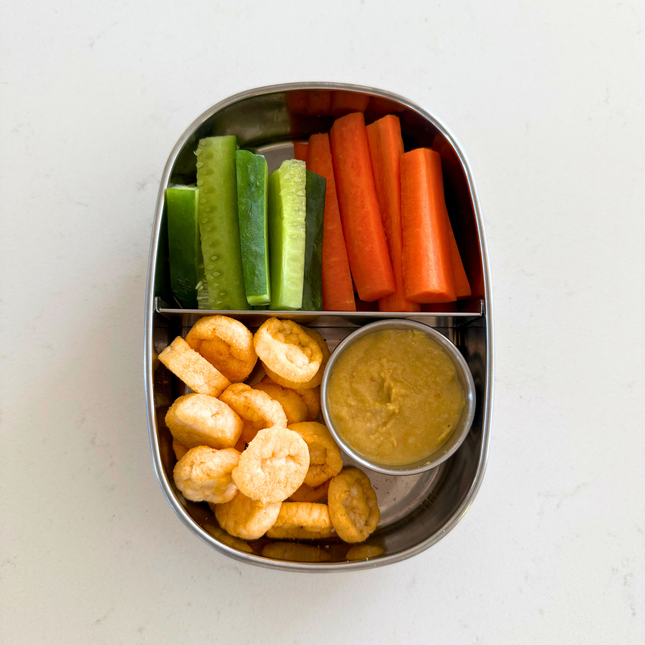Ever Eco 2 compartment stainless steel bento snack box filled with vegetables, crackers and snacks