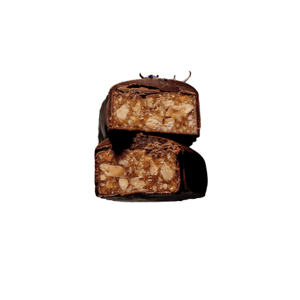 Cut-open chocolate bar showing chewy almond butter caramel and almond pieces