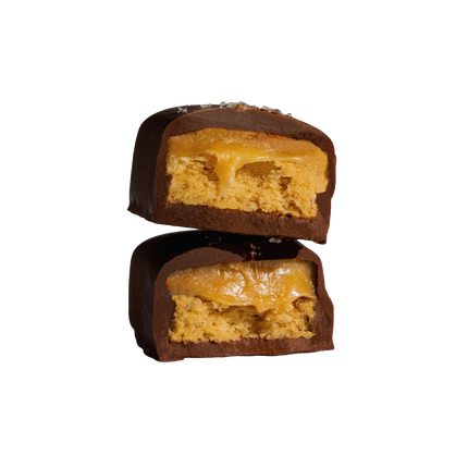 Cut-open chocolate bar showing vegan caramel and gluten-free shortbread layers