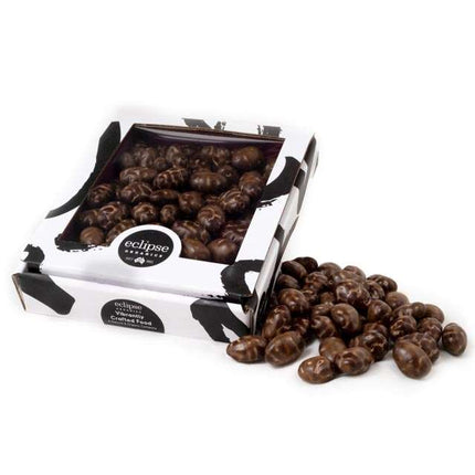 Box of Eclipse pet food with scattered treats on a white background