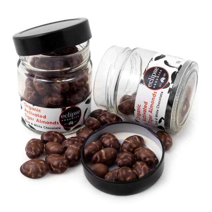 Jars of organic activated tiger almonds with visible branding on a white background