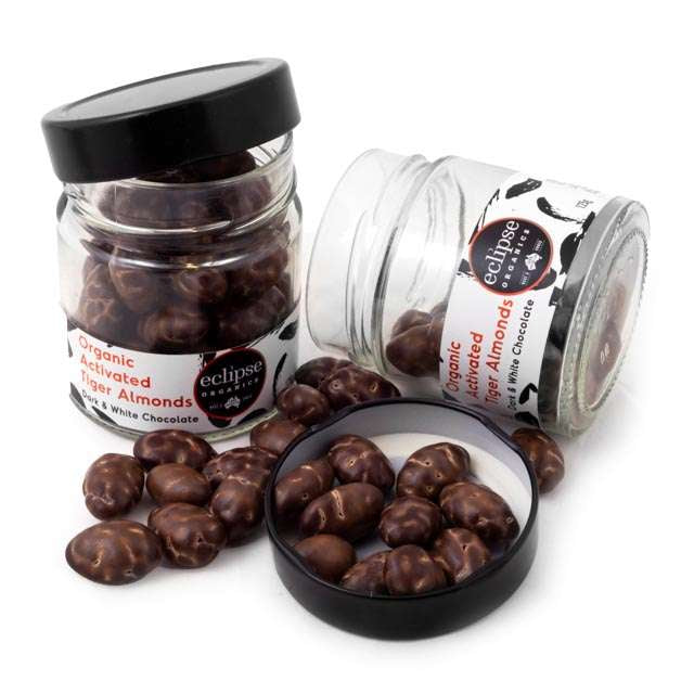 Jars of organic activated tiger almonds with visible branding on a white background
