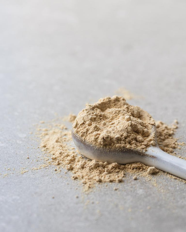 Power Super Foods maca powder served on a spoon
